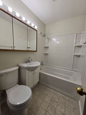 Hammond house for rent - A white toilet sits next to a sink in a bathroom.