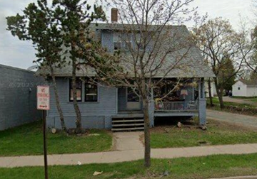 Wausau apartment for rent - A blue house with a sign in front of it.
