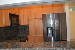 Austin apartment for rent - A kitchen with a stove, microwave, and refrigerator.