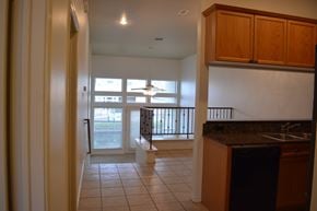 Austin apartment for rent - A kitchen with a black dishwasher and wooden cabinets.