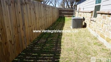 Burleson house for rent - A wooden fence runs along the side of a yard.