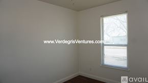 Burleson house for rent - A room with a window and a website address on the wall.
