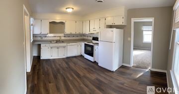 Spartanburg apartment for rent - A kitchen with white appliances and wooden floors.