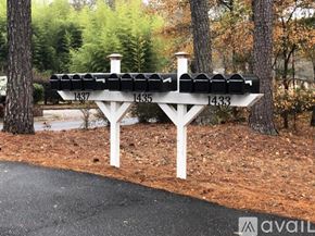 Spartanburg apartment for rent - A white bench with black cushions is labeled 1437, 1435, and 1433.