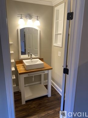 Spartanburg apartment for rent - A bathroom with a sink and mirror.