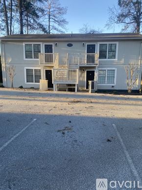 Spartanburg apartment for rent - A two-story apartment building with a parking lot in front.