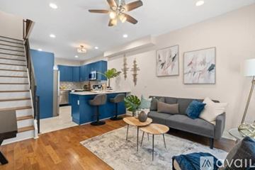 Philadelphia house for rent - A living room with a grey couch and a wooden coffee table.