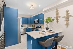Philadelphia house for rent - A kitchen with blue cabinets and a white island.