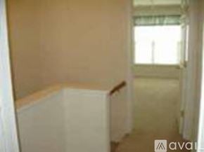 Richmond townhouse for rent - A room with a window and a white wall.