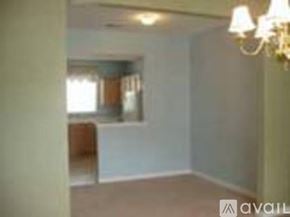 Richmond townhouse for rent - A room with a chandelier and a window.