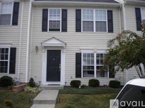 Richmond townhouse for rent - A house with a black front door and white trim.