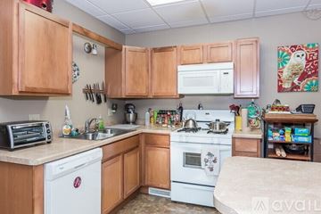 Madison apartment for rent - A kitchen with wooden cabinets and a white dishwasher.