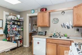 Madison apartment for rent - A kitchen with a white dishwasher and wooden cabinets.