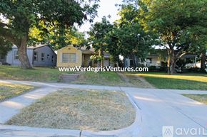 Fort Worth house for rent - A residential area with houses and a grassy area in the foreground.