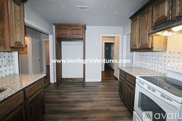 Fort Worth house for rent - A kitchen with wooden cabinets and a white countertop.