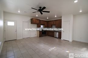 Fort Worth house for rent - A spacious room with a ceiling fan and tiled flooring.