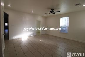 Fort Worth house for rent - A room with a ceiling fan and a window with a view of a building outside.