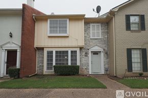 Shreveport townhouse for rent - A house with a red brick chimney and a white door.
