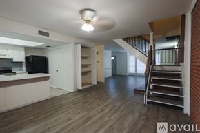 Shreveport townhouse for rent - A living room with a staircase leading to the upper floor.
