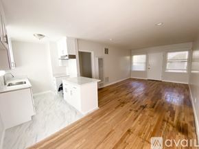Los Angeles apartment for rent - A spacious room with wooden flooring and white walls.