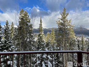 Breckenridge house for rent - A snowy landscape with trees and mountains in the distance.