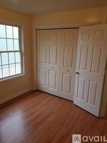 Hagerstown house for rent - A living room with a patterned couch and a small table.