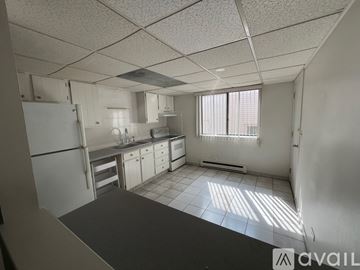 Forest Park condo for rent - A kitchen with white cabinets and appliances is available for rent.