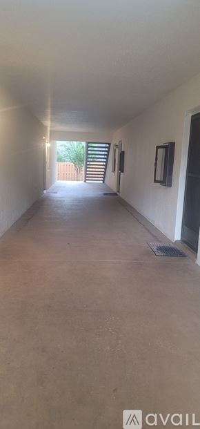 Ocala condo for rent - A long, empty hallway with a door at the end.
