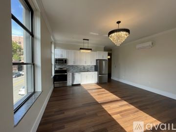 Elmira apartment for rent - A well-lit, spacious kitchen and living room with hardwood floors and a large window.