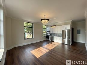 Elmira apartment for rent - A spacious kitchen with wooden floors and a large island.