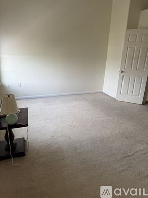 Stephens City townhouse for rent - A room with a white door and a lamp on a table.