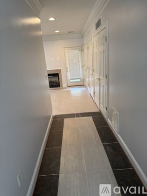 Stephens City townhouse for rent - A long hallway with a black and white striped tile floor.