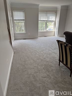 Stephens City townhouse for rent - A room with a striped chair and a car visible through the window.