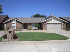 Oklahoma City house for rent - A house with a brick facade and a stone pillar in front.