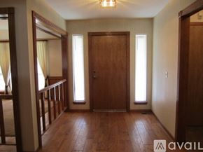 Oklahoma City house for rent - A room with wooden floors and a large mirror on the wall.