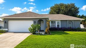Cape Coral house for rent - A house with a garage and a driveway in front of it.