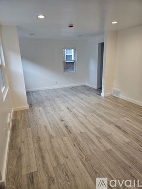 Pittsburgh apartment for rent - A spacious room with wooden flooring and a window.