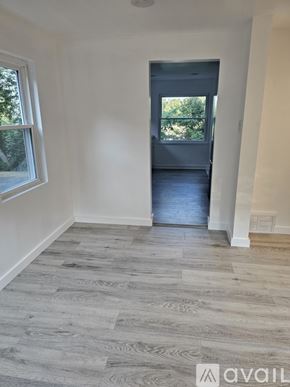 Pittsburgh apartment for rent - A room with a grey floor and a door leading to a balcony.