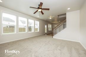 Murfreesboro house for rent - A spacious room with a fan and carpeted floor.
