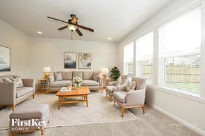 Murfreesboro house for rent - A well-lit living room with a variety of seating options and a ceiling fan.