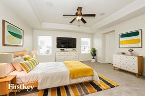 Murfreesboro house for rent - A bedroom with a bed, dresser, and ceiling fan.