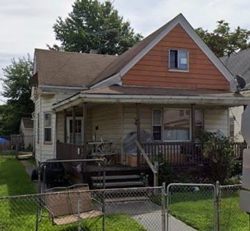 Cleveland house for rent - A small house with a brown roof and a white porch.