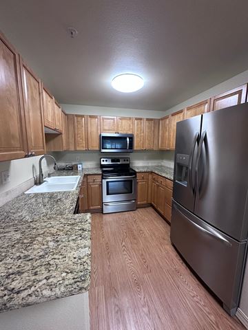 Post Falls apartment for rent - A kitchen with a granite counter top and stainless steel appliances.