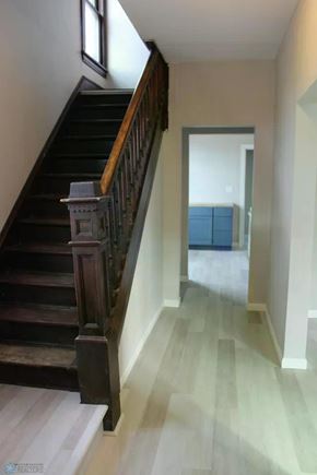Fargo house for rent - A staircase with a wooden handrail and steps leading up to a doorway.