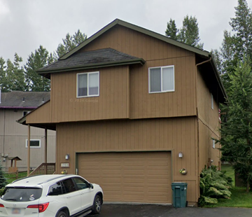 Anchorage house for rent - A brown house with a white car in front.