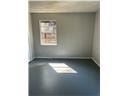 Mobile house for rent - A room with a poster on the wall and a light on the floor.
