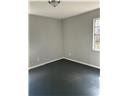 Mobile house for rent - A room with a grey wall and a white ceiling.