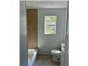 Mobile house for rent - A bathroom with a toilet and a mirror.