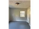 Mobile house for rent - A room with a window and a ceiling light.