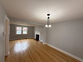 Hartford house for rent - A room with wooden floors and a fireplace.